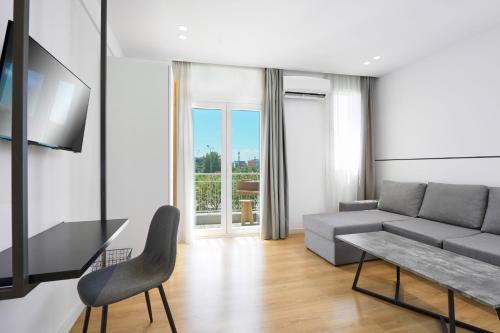a living room with a couch and a tv at Elephant Suites in Thessaloniki