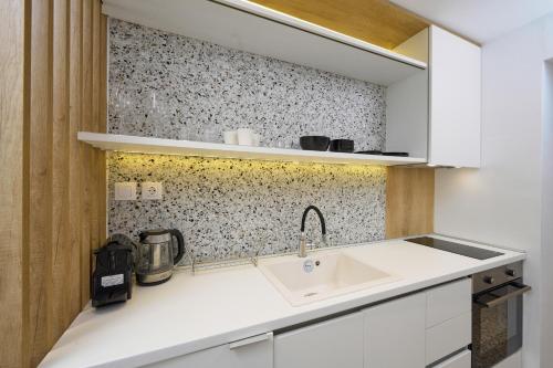 a kitchen with a sink and a counter top at Elephant Suites in Thessaloniki