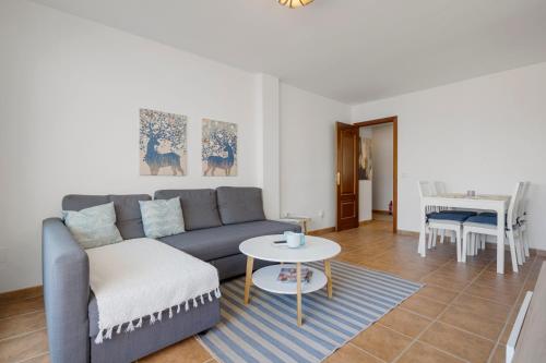 a living room with a couch and a table at Smart flat close to Fuengirola beach - Ref 94 in Fuengirola