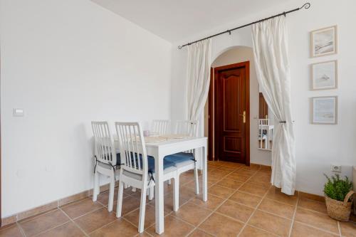 a white table and chairs in a white room at Smart flat close to Fuengirola beach - Ref 94 in Fuengirola