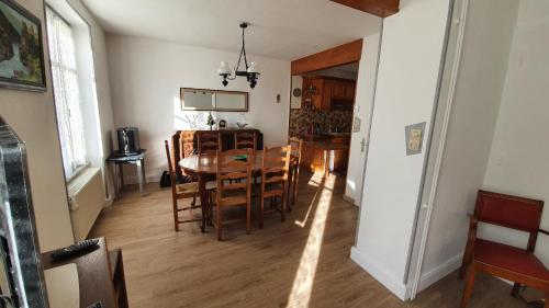 a dining room and kitchen with a table and chairs at GITE LE HOLWECK Gérardmer in Gérardmer