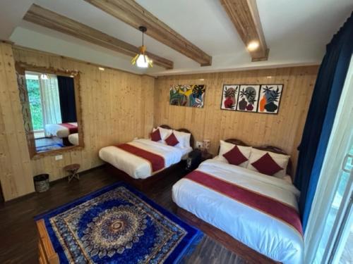 a room with two beds and a window at Amaira Resort & Farms - Mirik, West Bengal in Mirik