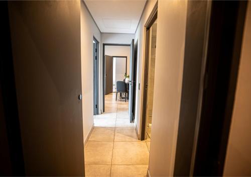 a hallway leading to a room with a table at The Catalyst Apartment Hotel by NEWMARK in Johannesburg
