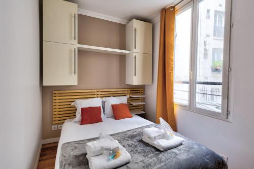 a bedroom with a bed with two pillows and a window at 316 Suite BIOT 6 - Superb apartment in Paris in Paris