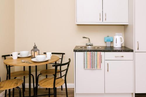 a kitchen with a small table and a sink at Easkey Glamping Village in Easkey