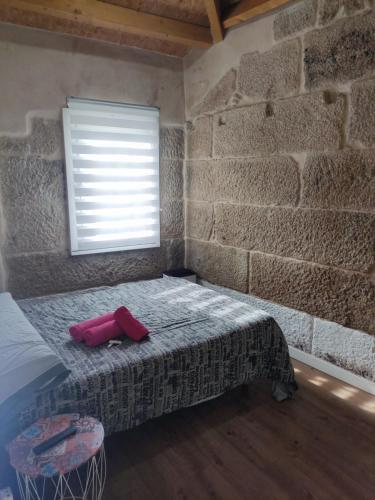 a bedroom with a bed in a brick wall at Pleno Casco Vello, Céntrico, Reformado 2023 in Vigo