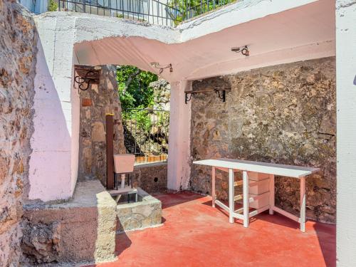 a table in a room with a stone wall at Villa Lisinj apartments in Dapčevići