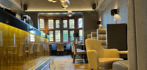 a restaurant with chairs and a table in a room at Abbey House Hotel in Barrow in Furness