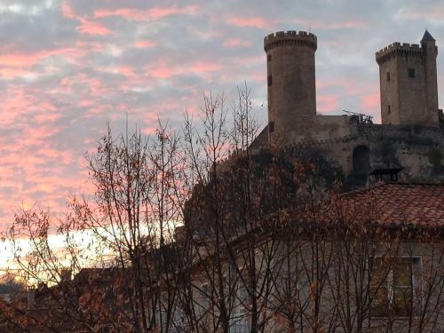 a building with two towers on top of it at Le gîte du bonheur in Dalou