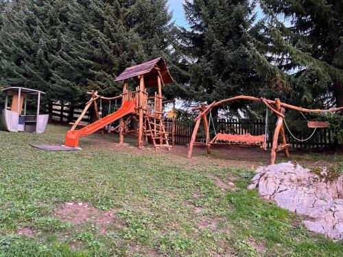 a playground in a yard with a slide at Penzion Aurelia Donovaly in Donovaly
