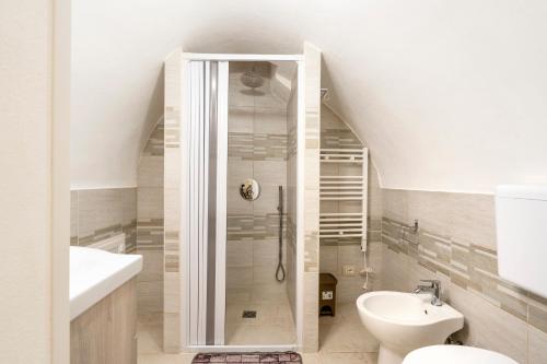 a bathroom with a shower and a toilet and a sink at Casa Vita 49 in Ceglie Messapica