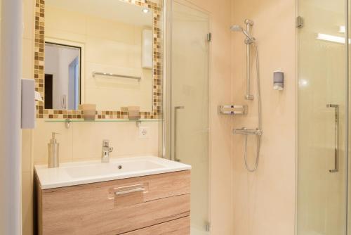 a bathroom with a sink and a shower at Apartment Seeblick in Zell am See