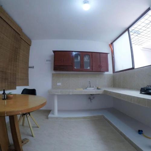 a kitchen with a sink and a table at Casa Hotel Piedra del Sol in Betania