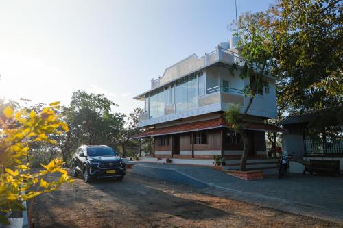 a car parked in front of a building at PADMA VILLAGE in Thodupuzha