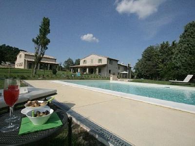 a table with a bowl of food next to a swimming pool at Agriturismo Vellaneta in Cagli