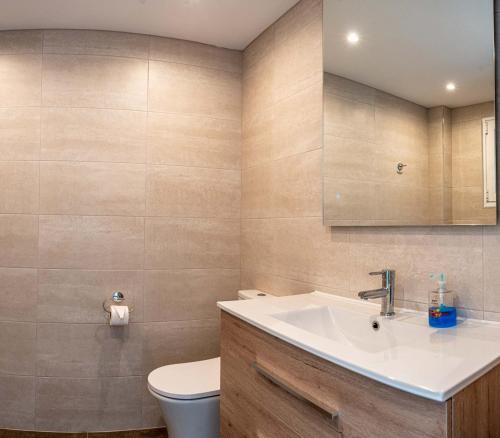 a bathroom with a sink and a toilet at Golf/Seaview 2 bedroom apartment in Sitio de Calahonda - Mijas in Mijas
