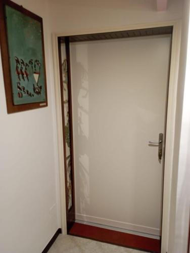 een witte deur in een kamer met een foto aan de muur bij Studio Notte Guest Rooms in Telese