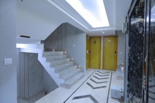 a hallway with a staircase in a house at Hotel Glitz - Walk in from New Delhi Railway Station in New Delhi