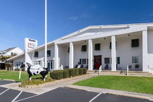 a statue of a cow in front of a building at Days Inn by Wyndham Kill Devil Hills Oceanfront - Wilbur in Kill Devil Hills
