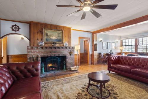 a living room with a couch and a fireplace at Days Inn by Wyndham Kill Devil Hills Oceanfront - Wilbur in Kill Devil Hills