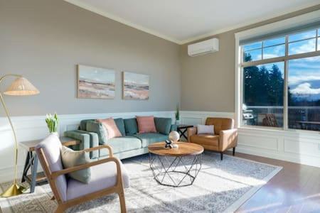 a living room with a couch and chairs and a table at Fremont home with panoramic views near Woodland Zoo in Seattle