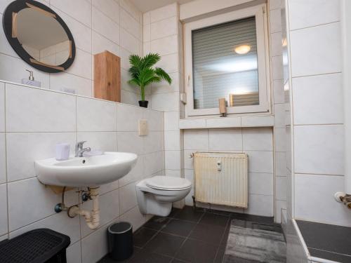 baño con lavabo y aseo y ventana en SR24 - gemütliches Apartment 2 in Recklinghausen, en Recklinghausen