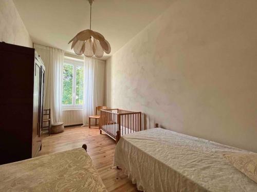 a bedroom with two beds and a window at Maison Favori in Le Beugnon