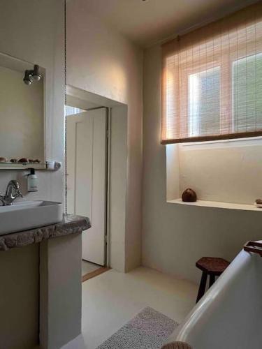 a bathroom with a sink and a mirror at Maison Favori in Le Beugnon
