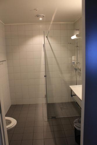 a bathroom with a shower and a toilet at Bardufosstun in Bardufoss