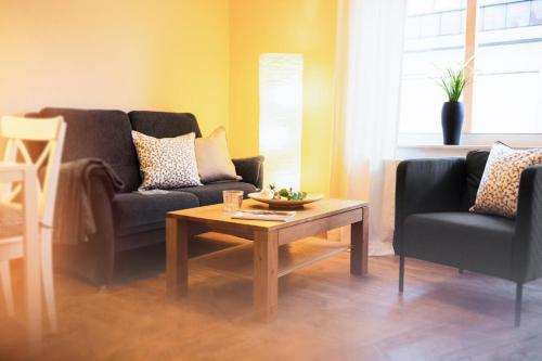 a living room with two couches and a coffee table at Haus Jelena Appartement 1 in Borkum