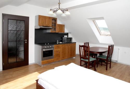 a kitchen and dining room with a table and chairs at Pivovar a restaurace Faltus in Česká Třebová