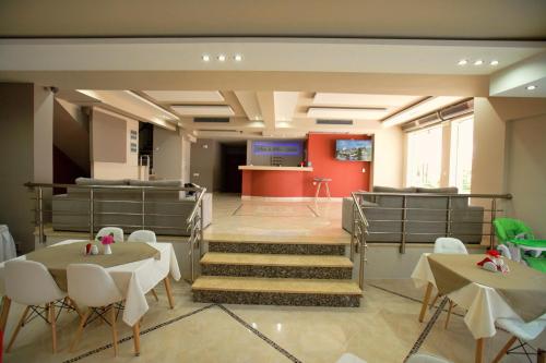 a waiting room with tables and chairs and a counter at SunSea Hotel Petra in Petra