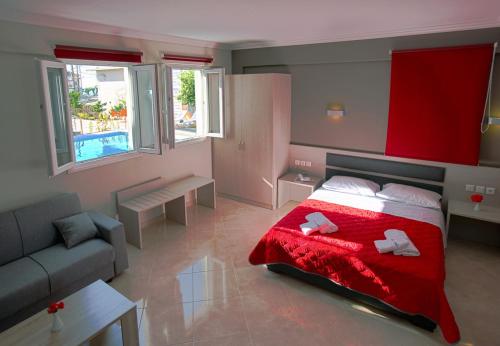a bedroom with a red bed and a couch at SunSea Hotel Petra in Petra