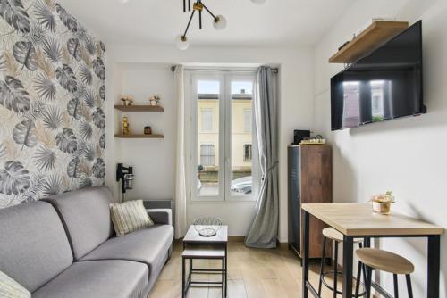 a living room with a couch and a table at 821 Suite Licorne - Superb apartment in Les Lilas