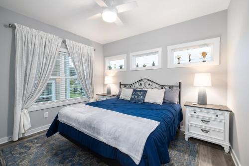 a bedroom with a blue bed and a window at Cozy Lake Cottage W/ Kayaks, SUPs, Pool & Firepit in Winchester