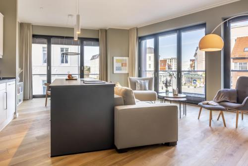 a kitchen and living room with a view of a city at Sparkassengebäude Wohnung 2 in Borkum