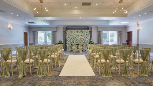 a room with a bunch of chairs and a table at DoubleTree by Hilton St. Anne's Manor in Bracknell