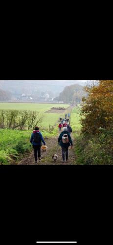 a group of people walking down a dirt road at Loft serenity du condroz in Tinlot