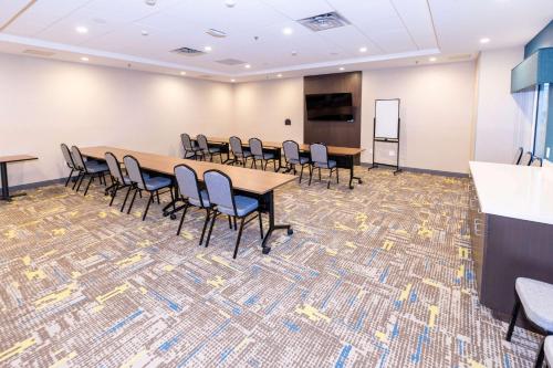 a conference room with tables and chairs and a screen at Hampton Inn Selma, Ca in Selma