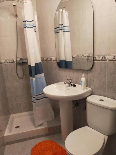 a bathroom with a sink and a toilet and a shower at CASA MANUELA in Suances