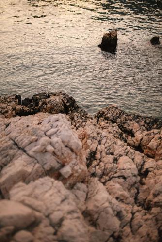 a group of rocks on the shore of a body of water at Lures Hotel in Kalkan