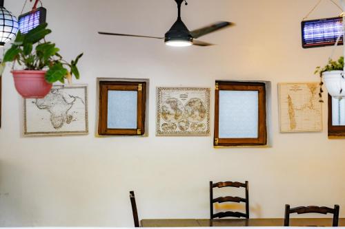 a dining room with a table and a ceiling fan at Emerald Palm Courtyard Hotel in Zanzibar City
