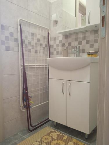 a bathroom with a sink and a shower at MAL Apartman in Soko Banja