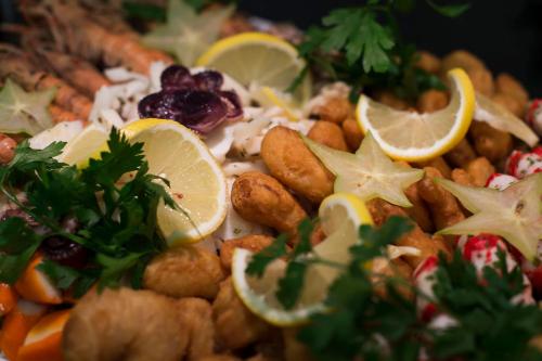 a plate of food with nuts and lemon slices at MariSol in Świnoujście