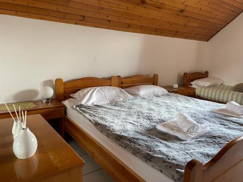 a bedroom with a large bed and a table at Apartma AS in Podčetrtek