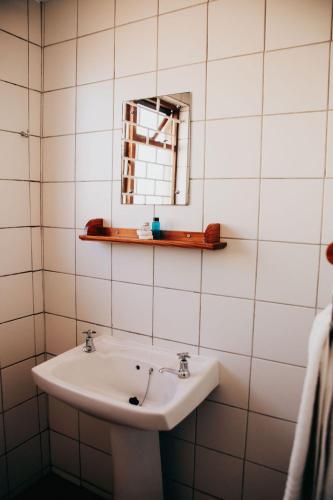 a bathroom with a sink and a mirror at Laaiplek Hotel in Velddrif