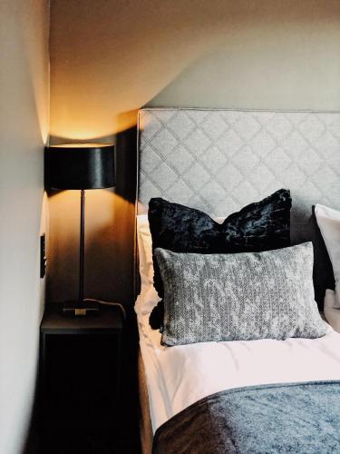 a bedroom with a bed with a pillow and a lamp at Quality Hotel Grand Royal in Narvik