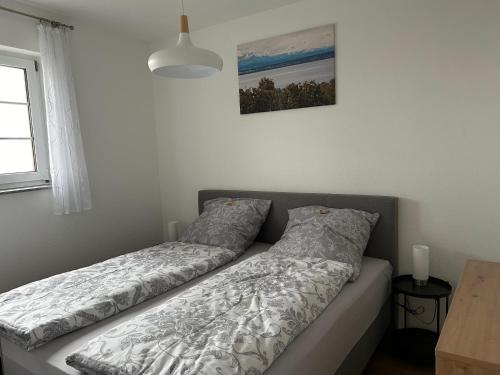 a bed with two pillows on it in a bedroom at Stilvolle und moderne Ferienwohnung in Stockach