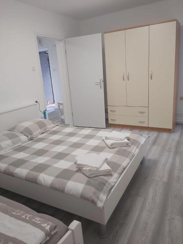 a bedroom with a large bed and white cabinets at Pepa Zg in Zagreb