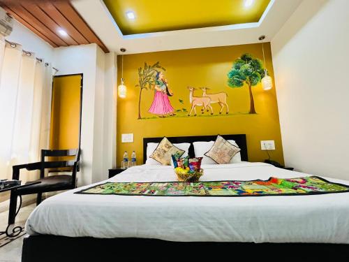 a bedroom with a bed with a painting on the wall at Hotel GVS-24 CLUB, Rooftop Cafe! swimming pool! Karaoke Music! in Udaipur